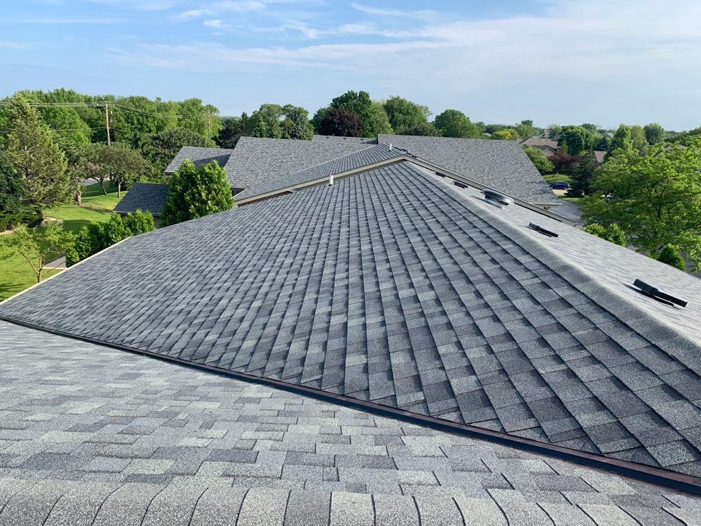 Close up shot of a residential roof with new gray shingles installed